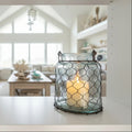 Decorative lantern with wire mesh design on a white background