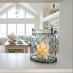 Decorative lantern with wire mesh design on a white background