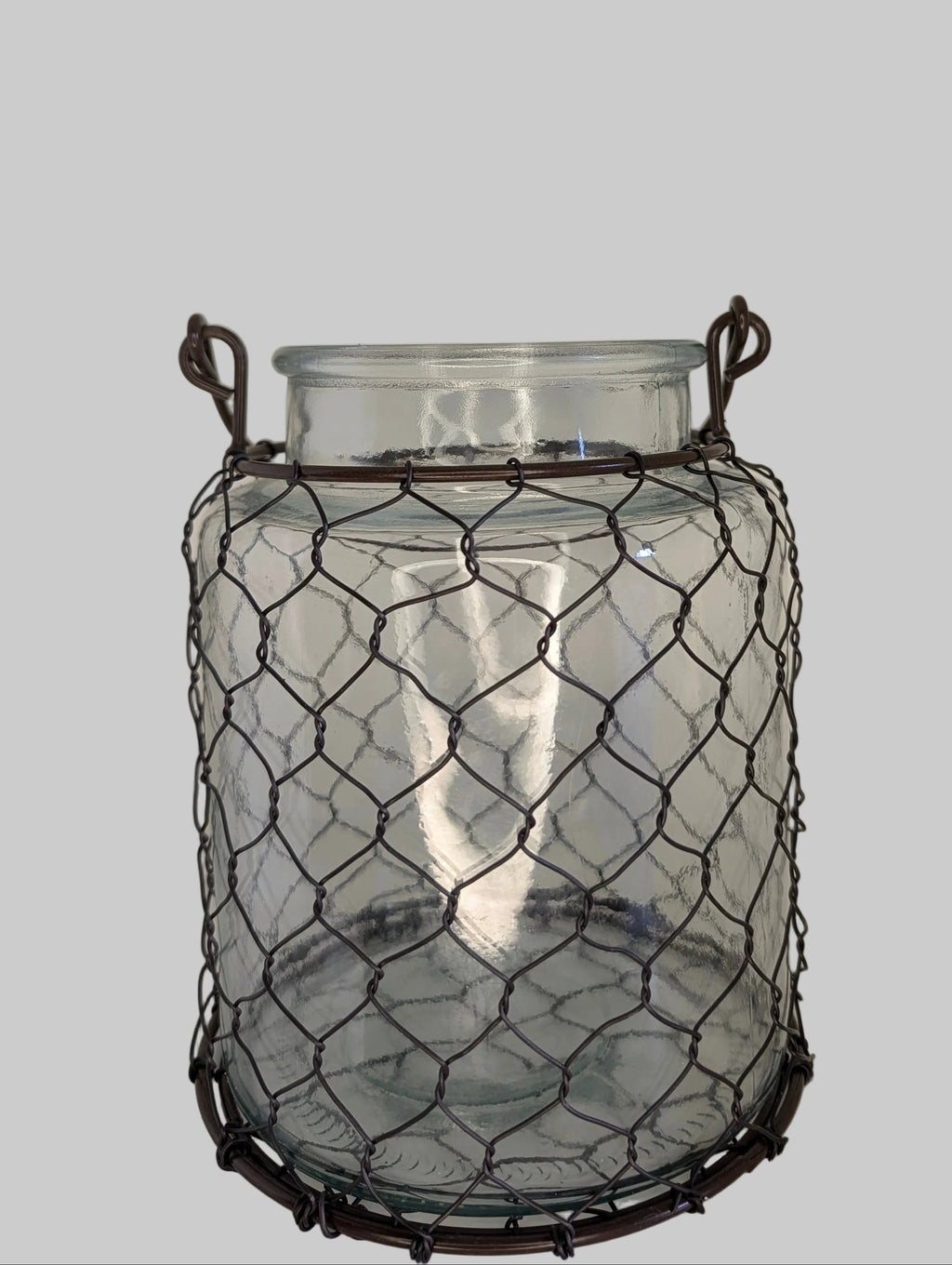 Glass jar with wire cage on a white background