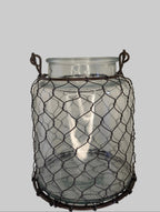Glass jar with wire cage on a white background