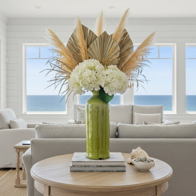 Green ceramic vase on a white shelf