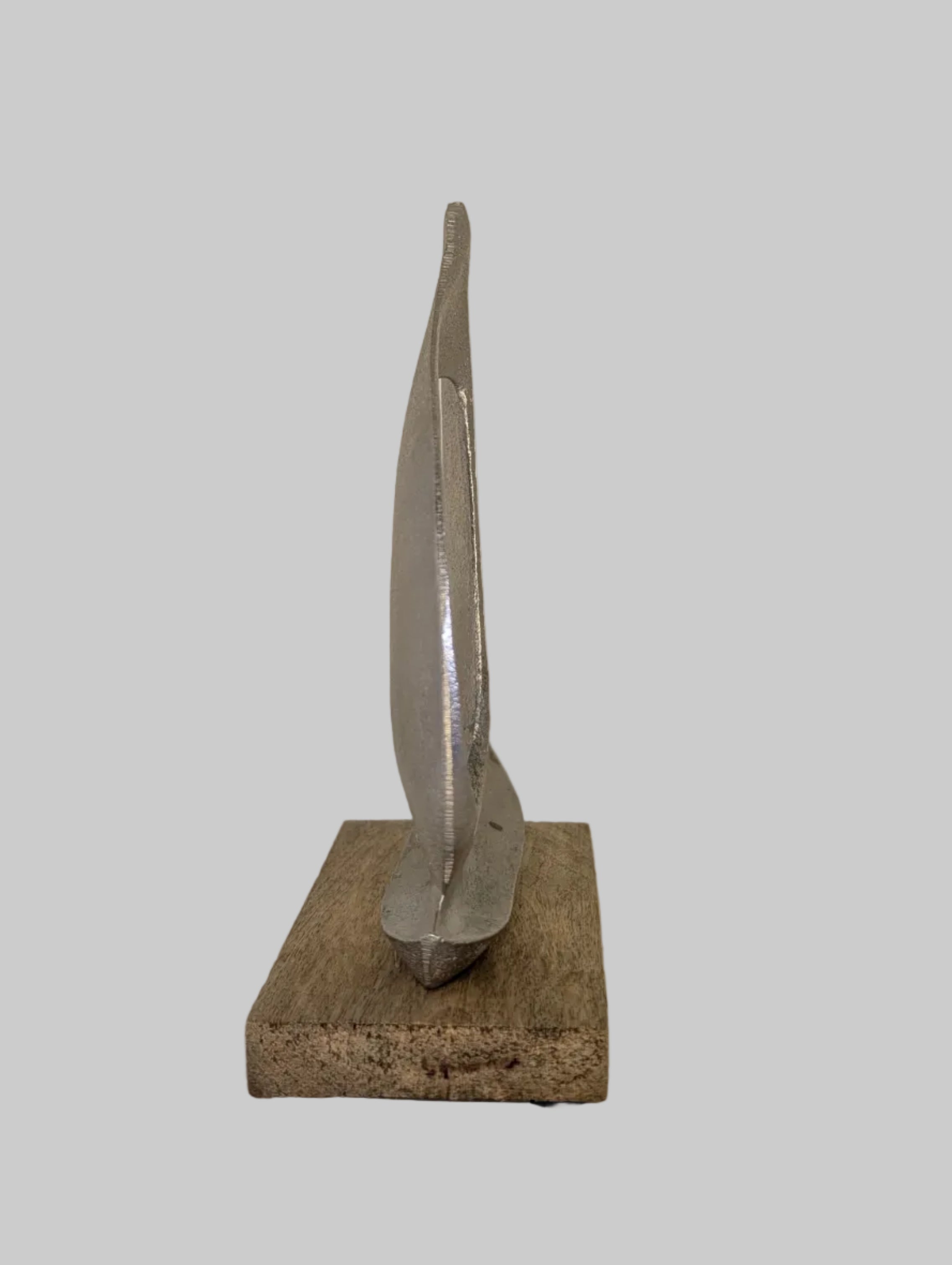 Abstract sculpture on a stand against a white background