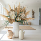White ceramic vase with decorative patterns on a white background