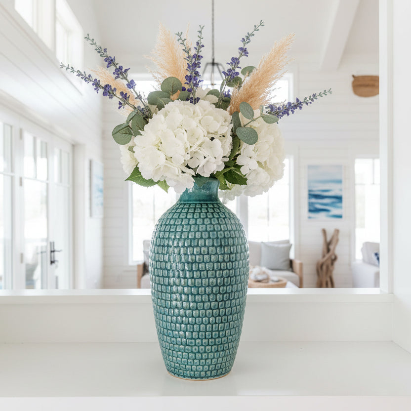 Blue textured vase on a white background