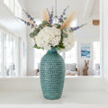 Blue textured vase on a white background